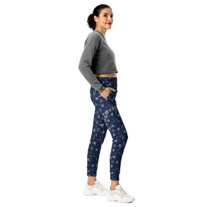 Woman wearing blue patterned jogging pants with a 'Fun Wear Code' text logo and a gray sweatshirt on a white background